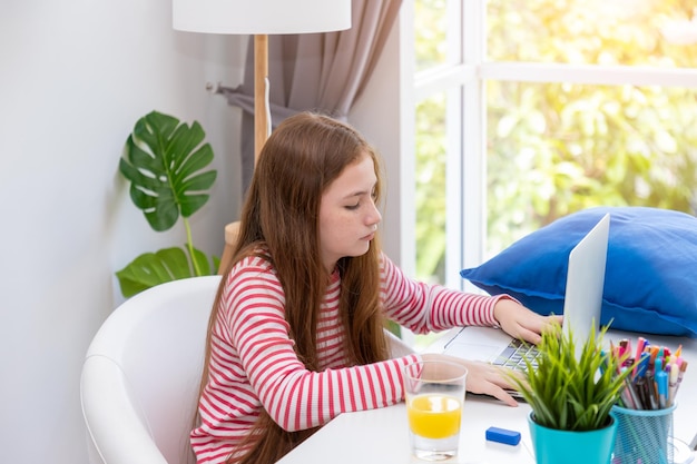 Girl using notebook computer laptop at home