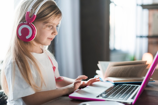 Girl using pink laptop