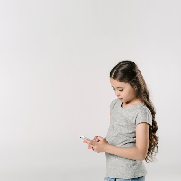 Girl using smartphone in studio