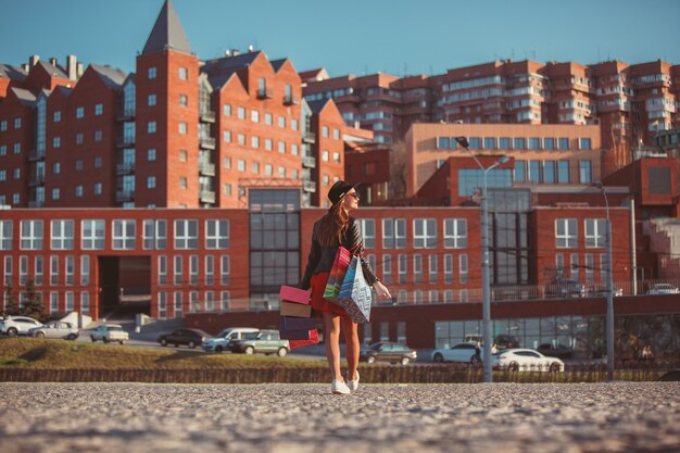 The girl walking with shopping on city streets