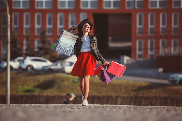 Free photo girl walking with shopping on city streets