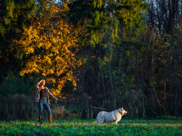 girl walks with husky