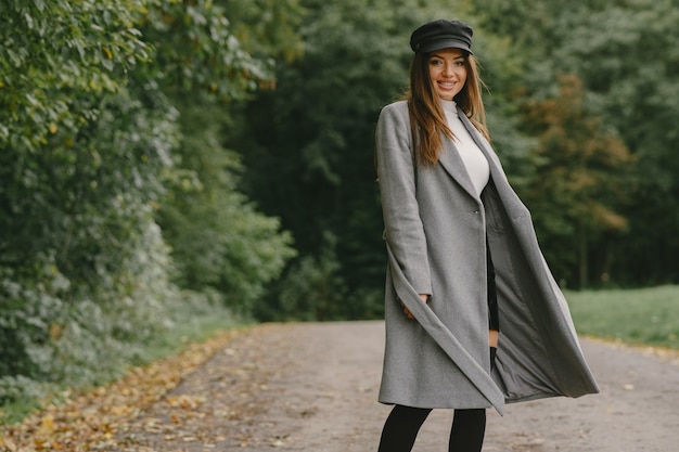 Free photo girl walks. woman in a gray coat. brunette with a black cap.