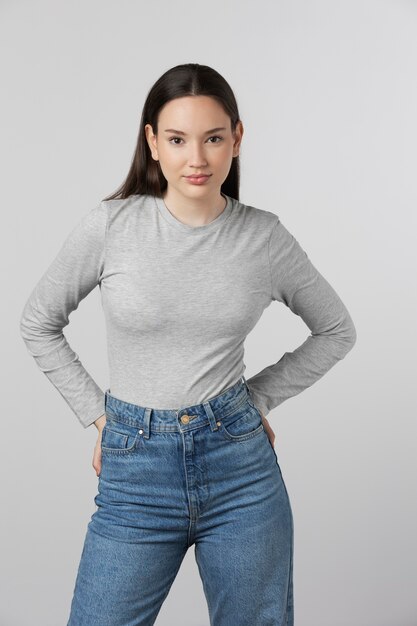 Girl wearing grey t-shirt posing in studio