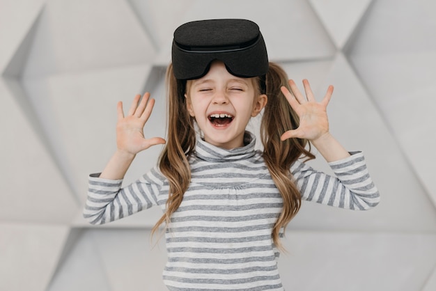 Girl wearing virtual reality headset and being happy