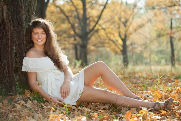 girl in white dress at autumn park