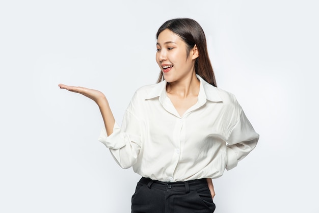 The girl in a white shirt holding something