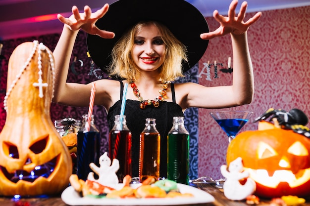 Free Photo girl in witch hat over table