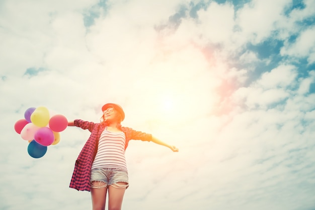 Girl with arms stretched and balloon