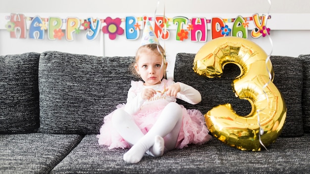 Free photo girl with balloon on sofa