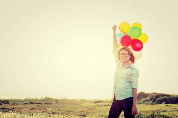 Free photo girl with balloons aloft