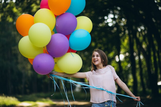 Girl with balloons in park