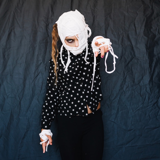 Free Photo girl with bandaged face pointing finger