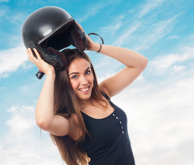 Free photo girl with black protection helmet under head.