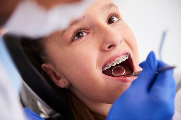 Girl with braces during a routine, dental examination