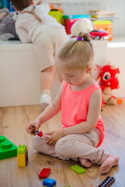 Girl with braid playing on floor