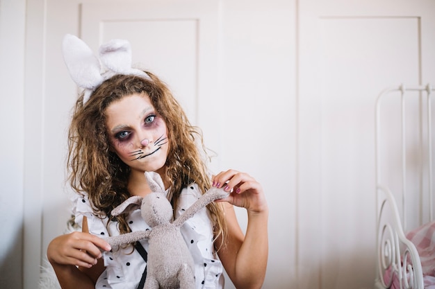 Free Photo girl with bunny ears and toy rabbit