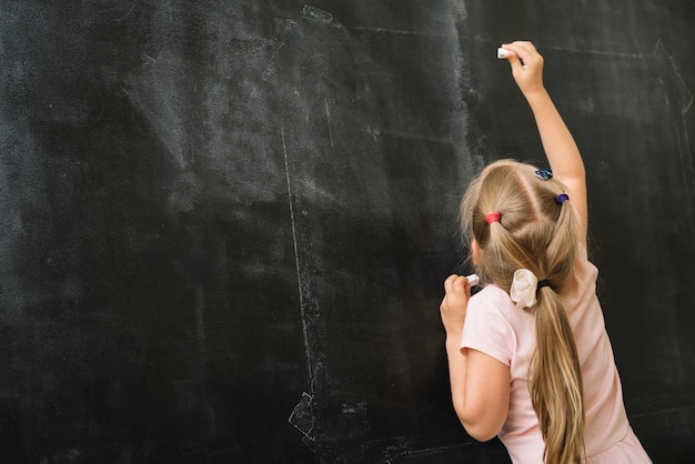 Free photo girl with chalk in class