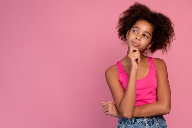 Girl with curly hair looking thoughtful