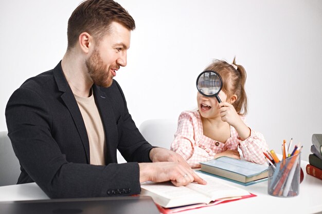 Girl with Down syndrome studying with her teacher at home