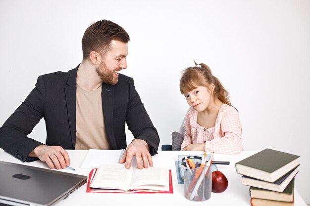 Girl with Down syndrome studying with her teacher at home