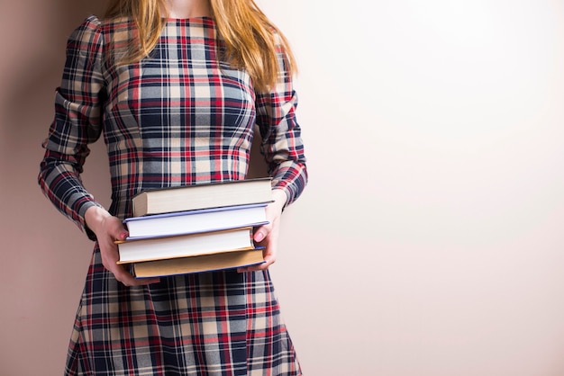 Free photo girl with dress holding several books