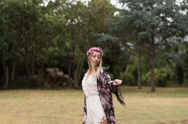 Free photo girl with floral wreath in the park