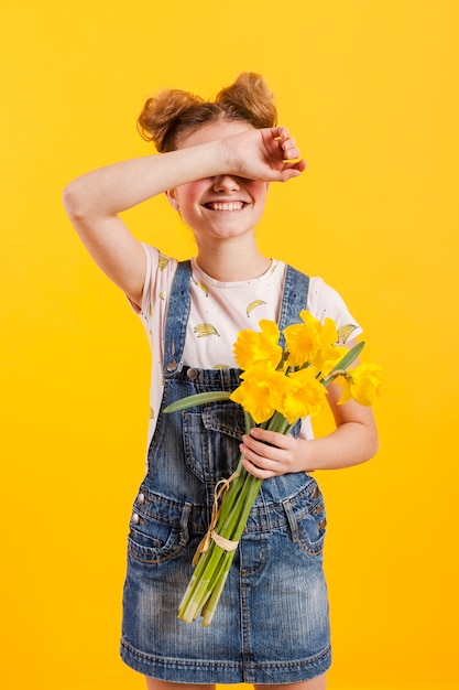 Free photo girl with flowers covering eyes