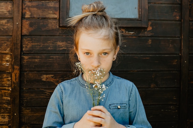 Free photo girl with flowers near shed