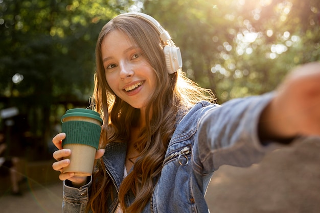 Girl with headphones listening music outdoor