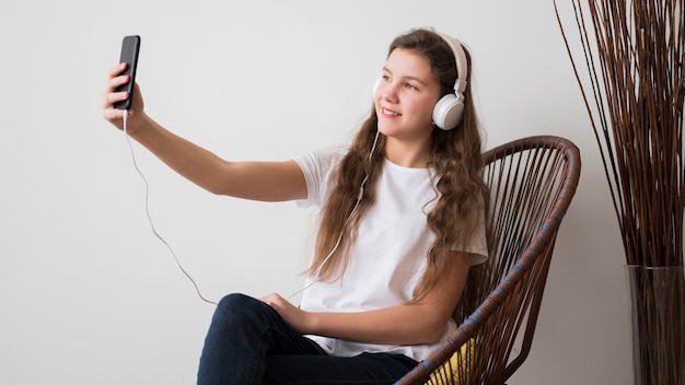 Free Photo girl with headphones taking selfie