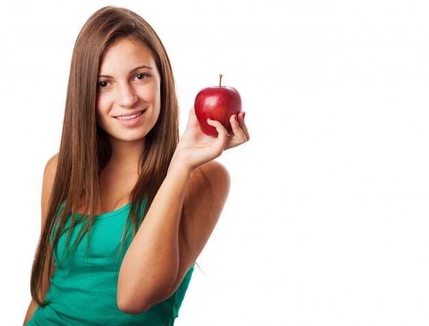 Girl with long hair posing with an apple