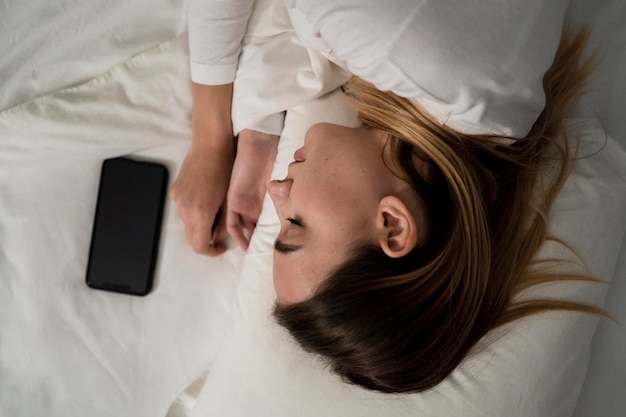 Girl with mobile while sleeping