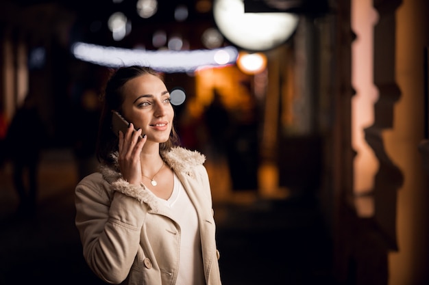 Girl with phone at night