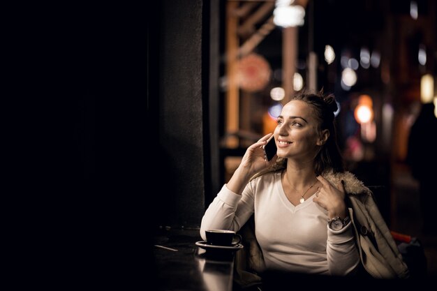 Girl with phone at night