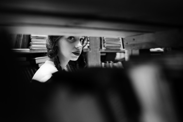 Free photo girl with pigtails in white blouse at old library