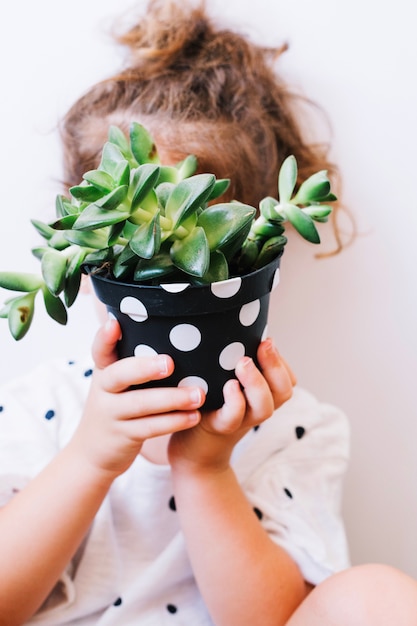 Free photo girl with potted plant