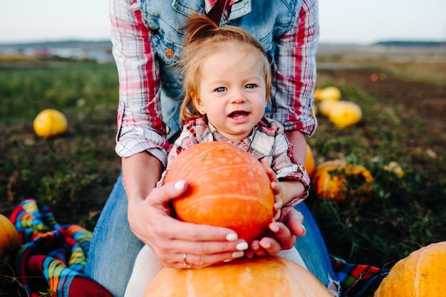 Girl with a pumpkin in front of her