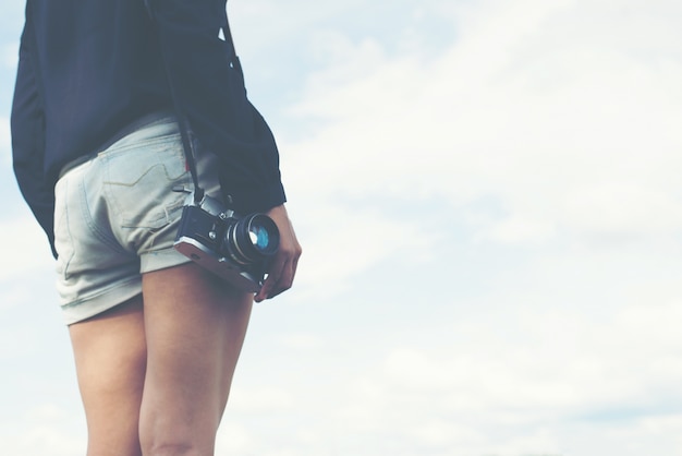 Girl with a reflex and clouds