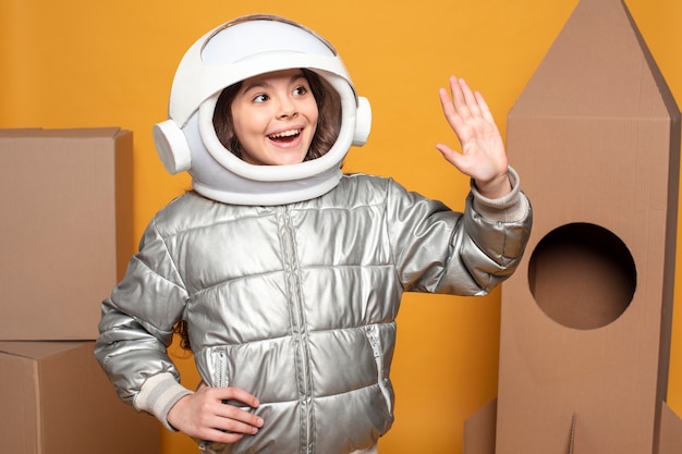 Girl with space helmet waving