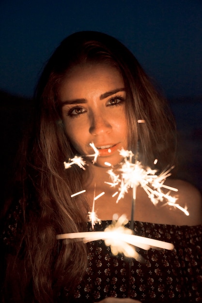 Free Photo girl with sparkler at night