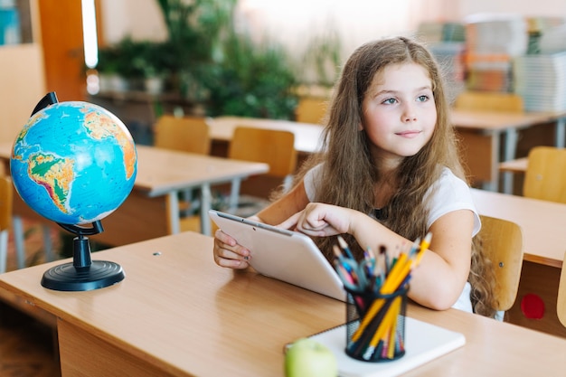 Girl with tablet looking away