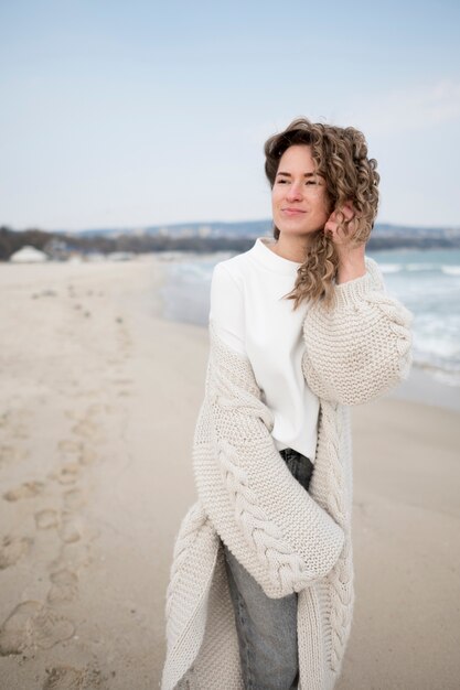 Girl  with wavy hair alongside sea