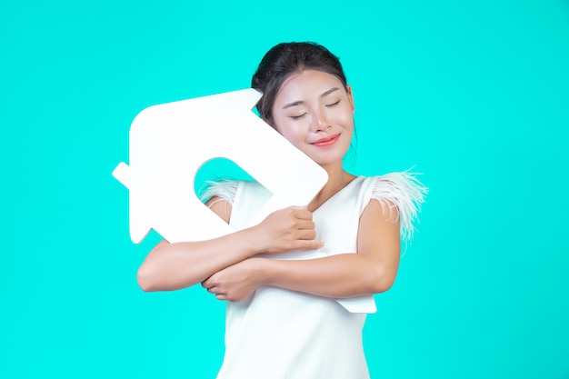 The girl wore a white long-sleeved shirt with floral pattern, holding the house symbol and showing various gestures with a blue .