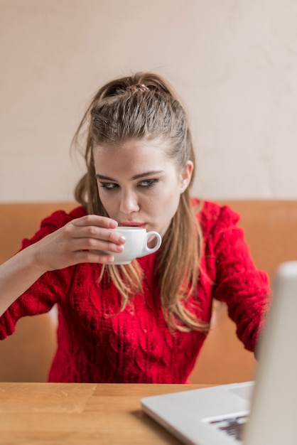 Girl working and drinking a coffee