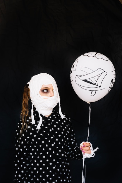 Free photo girl wrapped in bandage with balloon