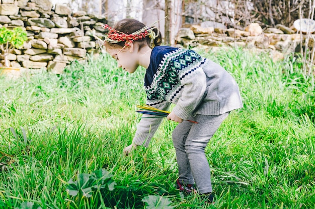 Free photo girl in wreath playing in garden