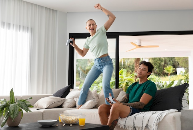 Girlfriend and boyfriend playing video games together at home