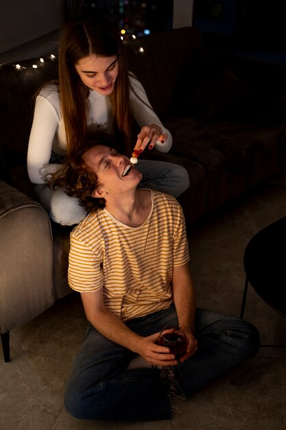 Girlfriend feeding boyfriend while at home together