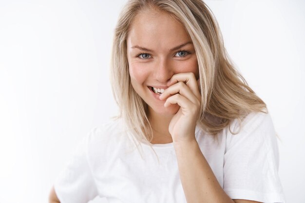 girlfriend giggling flirty coning smile with fingers gazing at camera playfully